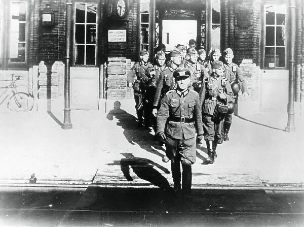 German army officer leading his company onto a railway station platform, Paris, August 1940