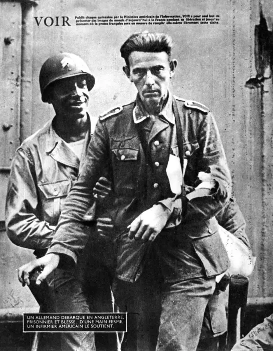 Framed Print : German prisoner of war arriving in England, escorted by an American soldier, 1944 Framed Print : German prisoner of war arriving in England, escorted by an American soldier, 1944