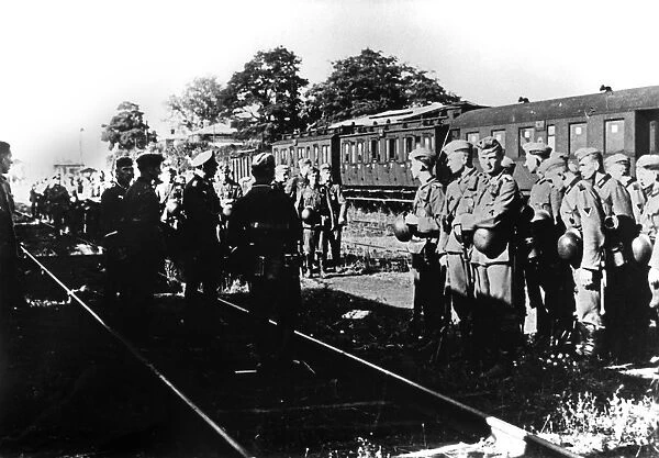 German soldiers awaiting transportation in a railway station in the Paris suburbs, August 1940