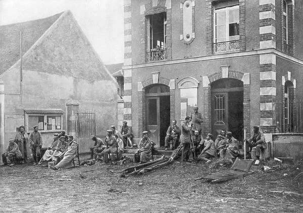 German troops sitting on the steps of the Vareddes Town Hall, France, 1914