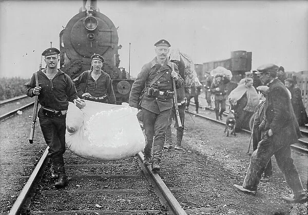 Germans helping refugees returning to Antwerp, 1914. Creator: Bain News Service