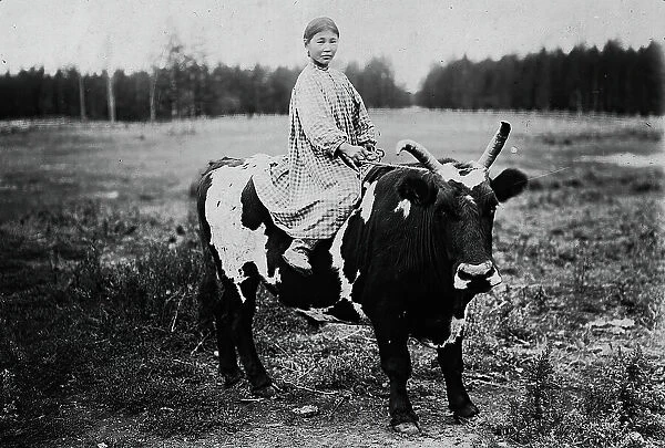 A girl riding a bull, 1890. Creator: Unknown