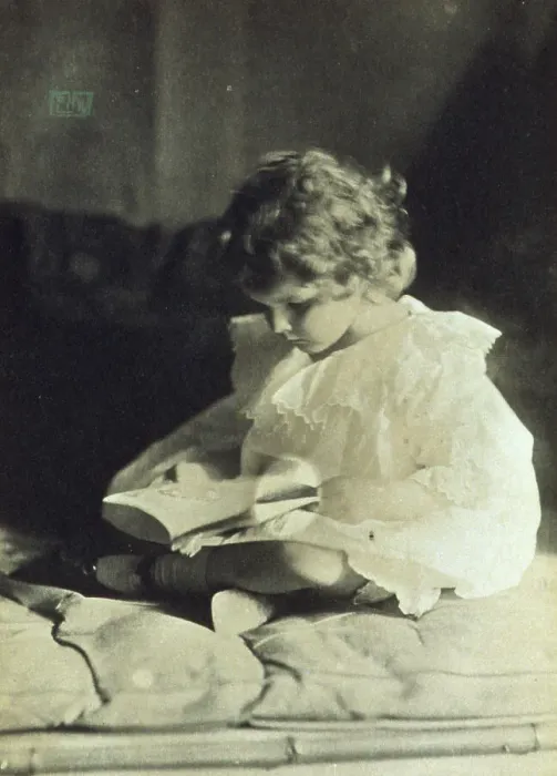 Framed Print : Girl sitting with legs folded, reading a book, c1900. Creator: Eva Watson-Schutze Framed Print : Girl sitting with legs folded, reading a book, c1900. Creator: Eva Watson-Schutze