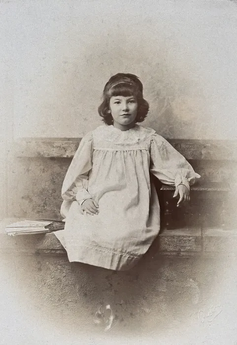 Framed Print : A girl, sitting on a stone bench with a fan folded at her side, c1890s. Creator: Arthur Reston Framed Print : A girl, sitting on a stone bench with a fan folded at her side, c1890s. Creator: Arthur Reston