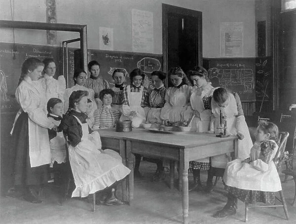Girls posed in home economics class, 1st Division, Washington, D.C. (1899?). Creator: Frances Benjamin Johnston