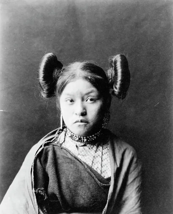 Framed Print : Gobuguoy, Walpi girl, half-length portrait, facing front, hair tied in swirls on sides of... c1900. Creator: Edward Sheriff Curtis Framed Print : Gobuguoy, Walpi girl, half-length portrait, facing front, hair tied in swirls on sides of... c1900. Creator: Edward Sheriff Curtis