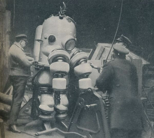 Going Down at Short Notice: A British Diver Preparing To Seek a Submarine at Sea Bottom, c1935