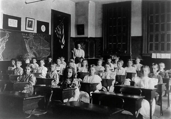 Grade school children posed in classroom, with teacher standing in back... Washington DC, (1899?). Creator: Frances Benjamin Johnston