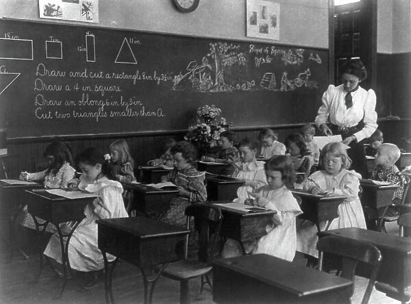 Grade school, Washington, D.C. - children drawing and cutting rectangles, triangles, etc. (1899?). Creator: Frances Benjamin Johnston