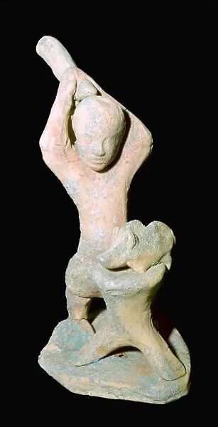 Greek terracotta statuette of a butcher with a pig