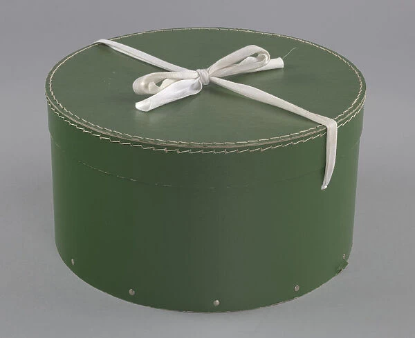 Green circular hatbox with lid from Maes Millinery Shop, 1941-1994. Creator: Unknown