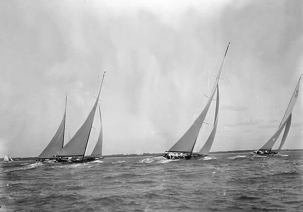 A group of 12 Metres sailing yachts racing on windward leg in good wind, 1933. Creator