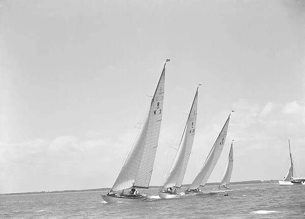 Group of 8 Metre sailing yachts racing close-hauled. Creator: Kirk & Sons of Cowes
