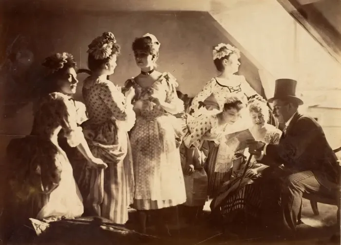 Framed Print : A Group of Six Costumed Women Posed in Interior with Top Hatted Gentlemen, c1885 Framed Print : A Group of Six Costumed Women Posed in Interior with Top Hatted Gentlemen, c1885
