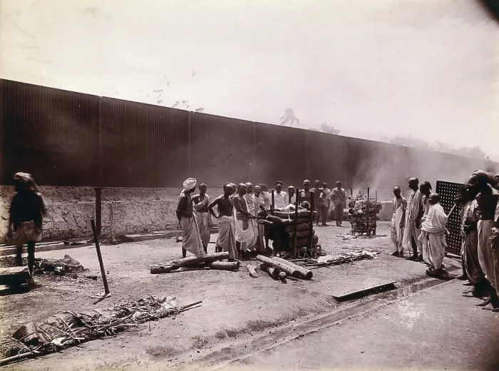 Framed Print : A group of men stand around the body of a man laid out on a pyre of logs during a Hindu... 1896 / 97 Creator: Unknown