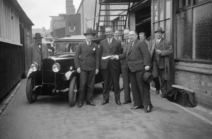 Framed Print : Group of men with a Triumph Super Seven, c1930(?). Artist: Bill Brunell Framed Print : Group of men with a Triumph Super Seven, c1930(?). Artist: Bill Brunell