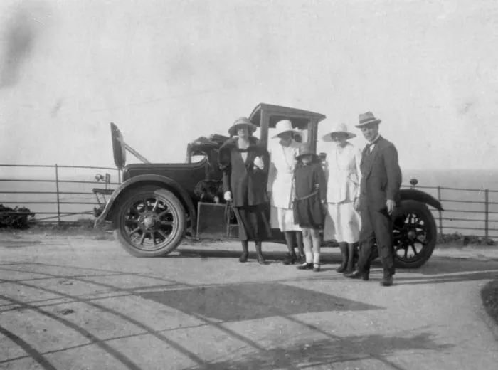 Framed Print : A group of people in front of their car at the seaside, c1920s(?) Framed Print : A group of people in front of their car at the seaside, c1920s(?)