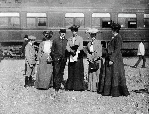 Group of people posed with railroad car behind them, Denver, Colorado, (1903?). Creator: Frances Benjamin Johnston