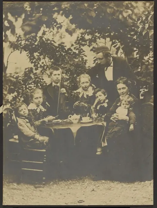 Framed Print : Group portrait around table, 1880-1890. Creator: Victor Dix