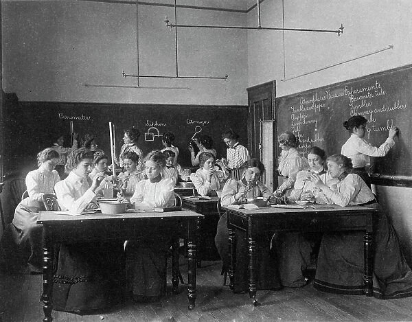 Group of young women performing atmospheric pressure experiments while studying... (1899?). Creator: Frances Benjamin Johnston