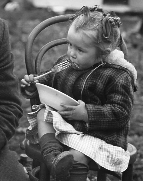 Gypsy girl eating, 1960s