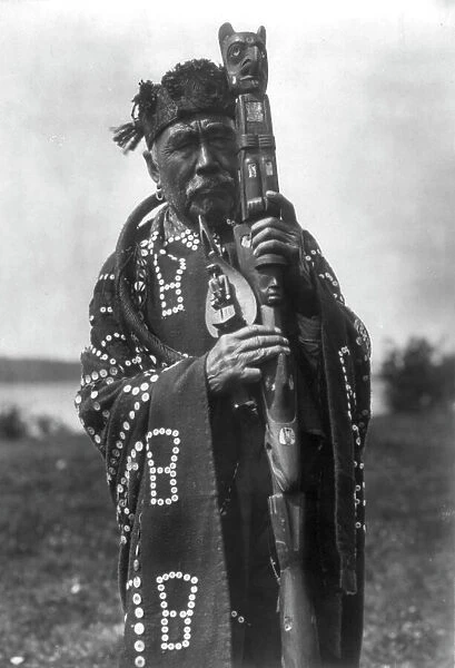 Hamasaka in Tluwulahu costume with speaker's staff-Qagyuhl [principal chief], c1914. Creator: Edward Sheriff Curtis