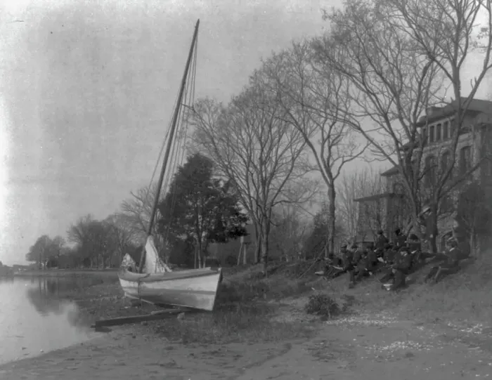 Framed Print : Hampton Institute students sketching a fishing boat at river bank. Hampton, Va. 1900. Creator: Frances Benjamin Johnston Framed Print : Hampton Institute students sketching a fishing boat at river bank. Hampton, Va. 1900. Creator: Frances Benjamin Johnston