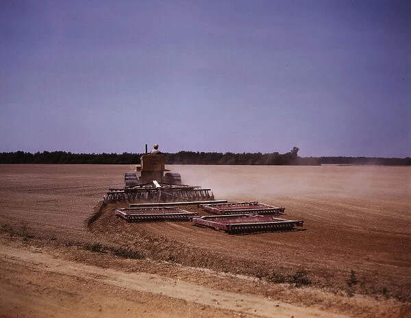 Harrowing a field with a diesel tractor, Seabrook Farm, Bridgeton, N. J. 1942. Creators: Marion Post Wolcott, John Collier
