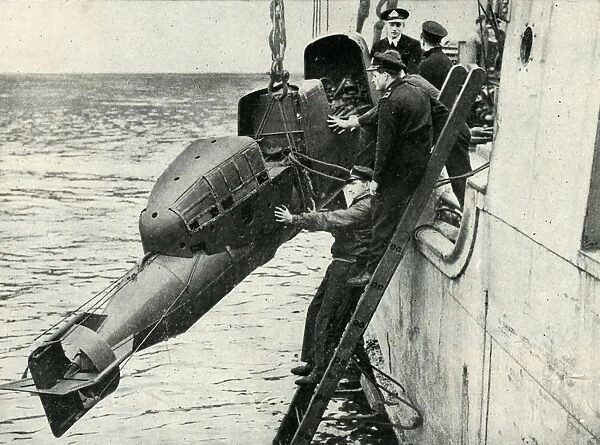 Hoisting a Chariot manned torpedo on board a ship, World War II, 1945. Creator: Unknown