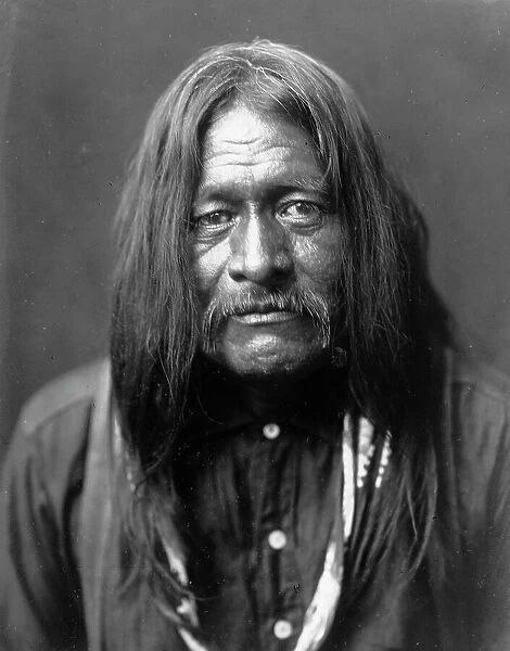 Hoo-Man-Hai, Maricopa Indian, head-and-shoulders portrait, facing front, c1907. Creator: Edward Sheriff Curtis