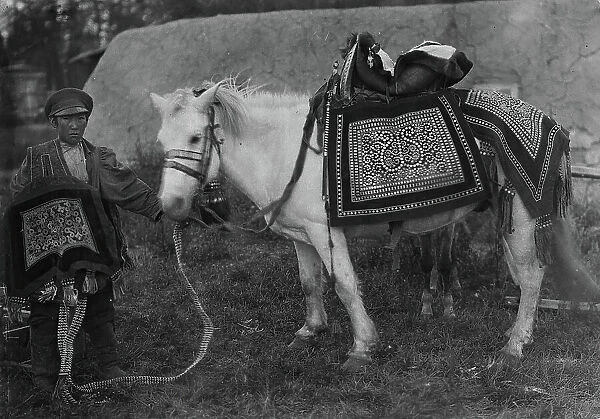 Horse in festive harness and rider in ceremonial attire, 1890. Creator: Unknown
