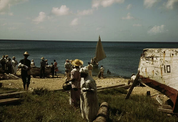 Housewives at the seashore waiting for the fishing boats to come in Frederiksted, V. I. 1941. Creator: Jack Delano