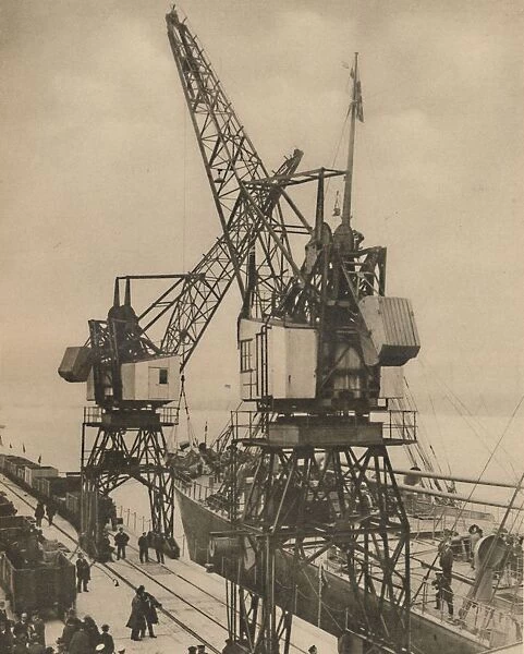 Huge Mobile Cranes at Tilbury Swing the Cargo from a Vessels Hold, c1935. Creator: Unknown