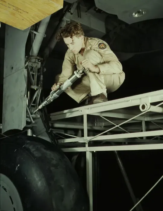 Framed Print : A hydraulic mechanic greasing the landing gear of a transport... Fort Worth, Texas, 1942. Creator: Howard Hollem Framed Print : A hydraulic mechanic greasing the landing gear of a transport... Fort Worth, Texas, 1942. Creator: Howard Hollem