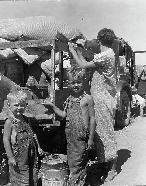Part of an impoverished family of nine on a New Mexico highway, 1936. Creator: Dorothea Lange
