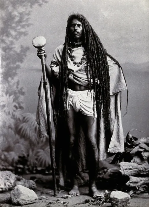 Framed Print : An Indian man with long hair, carrying a staff, in a studio setting, 1900. Creator: Unknown