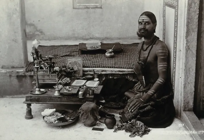 Framed Print : An Indian man wearing elaborate jewellery and make-up, squatting in front of a small table... c1900 Creator: Unknown Framed Print : An Indian man wearing elaborate jewellery and make-up, squatting in front of a small table... c1900 Creator: Unknown