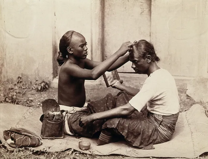 Framed Print : Two Indian men sitting cross-legged; one appears to be a barber... c1890s. Creator: Unknown Framed Print : Two Indian men sitting cross-legged; one appears to be a barber... c1890s. Creator: Unknown