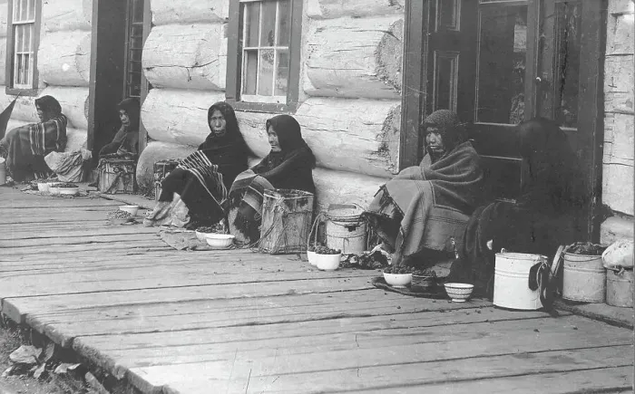 Framed Print : Indians sitting with backs to wall selling berries, between c1900 and c1930. Creator: Unknown Framed Print : Indians sitting with backs to wall selling berries, between c1900 and c1930. Creator: Unknown