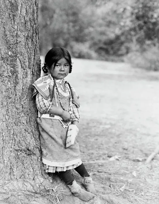Framed Print : Innocence, an Umatilla girl, full-length portrait, standing by tree, facing slightly right, c1910. Creator: Edward Sheriff Curtis Framed Print : Innocence, an Umatilla girl, full-length portrait, standing by tree, facing slightly right, c1910. Creator: Edward Sheriff Curtis