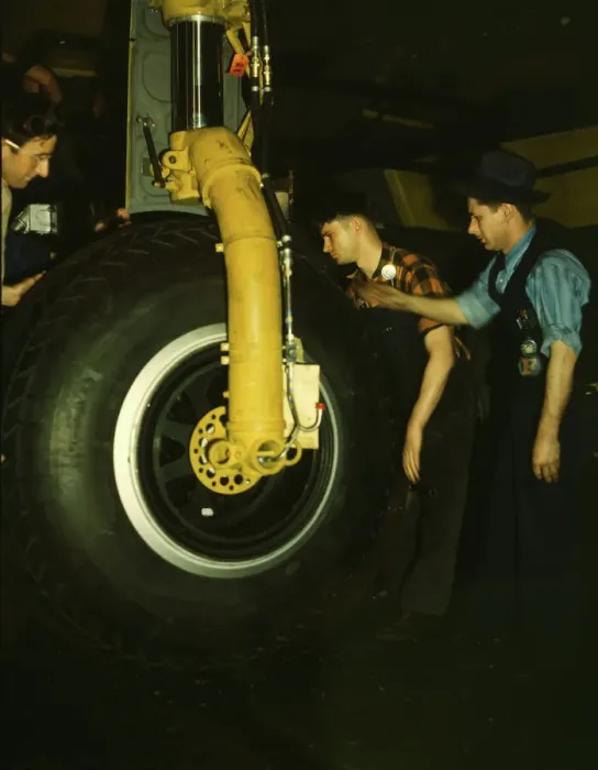 Framed Print : Inspecting of landing wheel of the transport planes at Willow Run, between 1941 and 1945. Creator: Howard Hollem Framed Print : Inspecting of landing wheel of the transport planes at Willow Run, between 1941 and 1945. Creator: Howard Hollem