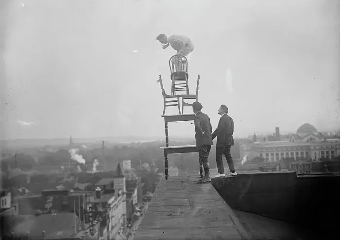 Framed Print : J. Reynolds, Performing Acrobatic And Balancing Acts On High Cornice Above 9th Street, N.W. 1917. Creator: Harris & Ewing. J. Reynolds, Performing Acrobatic And Balancing Acts On High Cornice Above 9th Street, N.W. 1917 Framed Print : J. Reynolds, Performing Acrobatic And Balancing Acts On High Cornice Above 9th Street, N.W. 1917. Creator: Harris & Ewing. J. Reynolds, Performing Acrobatic And Balancing Acts On High Cornice Above 9th Street, N.W. 1917
