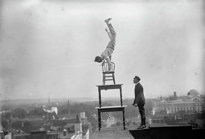 Framed Print : J. Reynolds, Performing Acrobatic And Balancing Acts On High Cornice Above 9th Street, N.W. 1917. Creator: Harris & Ewing. J. Reynolds, Performing Acrobatic And Balancing Acts On High Cornice Above 9th Street, N.W. 1917 Framed Print : J. Reynolds, Performing Acrobatic And Balancing Acts On High Cornice Above 9th Street, N.W. 1917. Creator: Harris & Ewing. J. Reynolds, Performing Acrobatic And Balancing Acts On High Cornice Above 9th Street, N.W. 1917