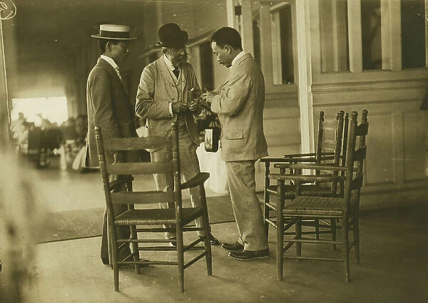 Two Japanese men and one American(?) man, probably journalists, conversing on the veranda... 1905. Creator: Unknown