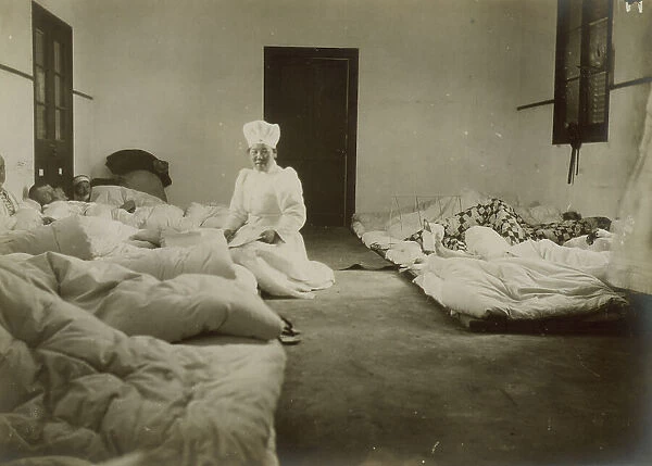 Japanese Red Cross nurses at Chemulpo attending Russian soldiers wounded in battle of Feb. 9, c1904. Creator: Robert Lee Dunn
