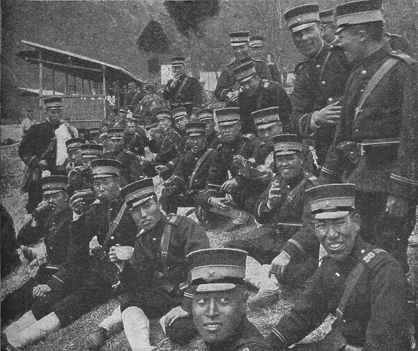 Japanese soldiers on the way to the front: the noonday meal of tea and rice, 1904-1905 (1907)