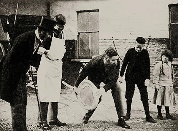 John Boyd Dunlop experiments with his pneumatic tire wheel, End of 1880s. Creator: Anonymous