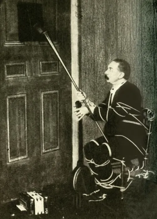 Framed Print : John Nevil Maskelyne performs a spirit cabinet illusion, c1910. Creator: Unknown Framed Print : John Nevil Maskelyne performs a spirit cabinet illusion, c1910. Creator: Unknown