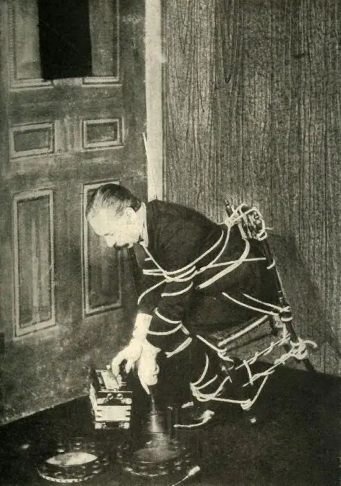 Framed Print : John Nevil Maskelyne performs a spirit cabinet illusion, c1910. Creator: Unknown Framed Print : John Nevil Maskelyne performs a spirit cabinet illusion, c1910. Creator: Unknown