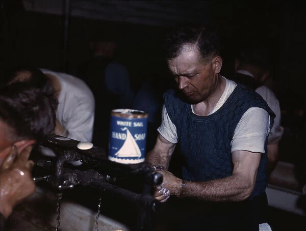 Joseph Klesken washing up after a days work... Proviso yards of the C & NW RR, Chicago, Ill. 1943. Creator: Jack Delano